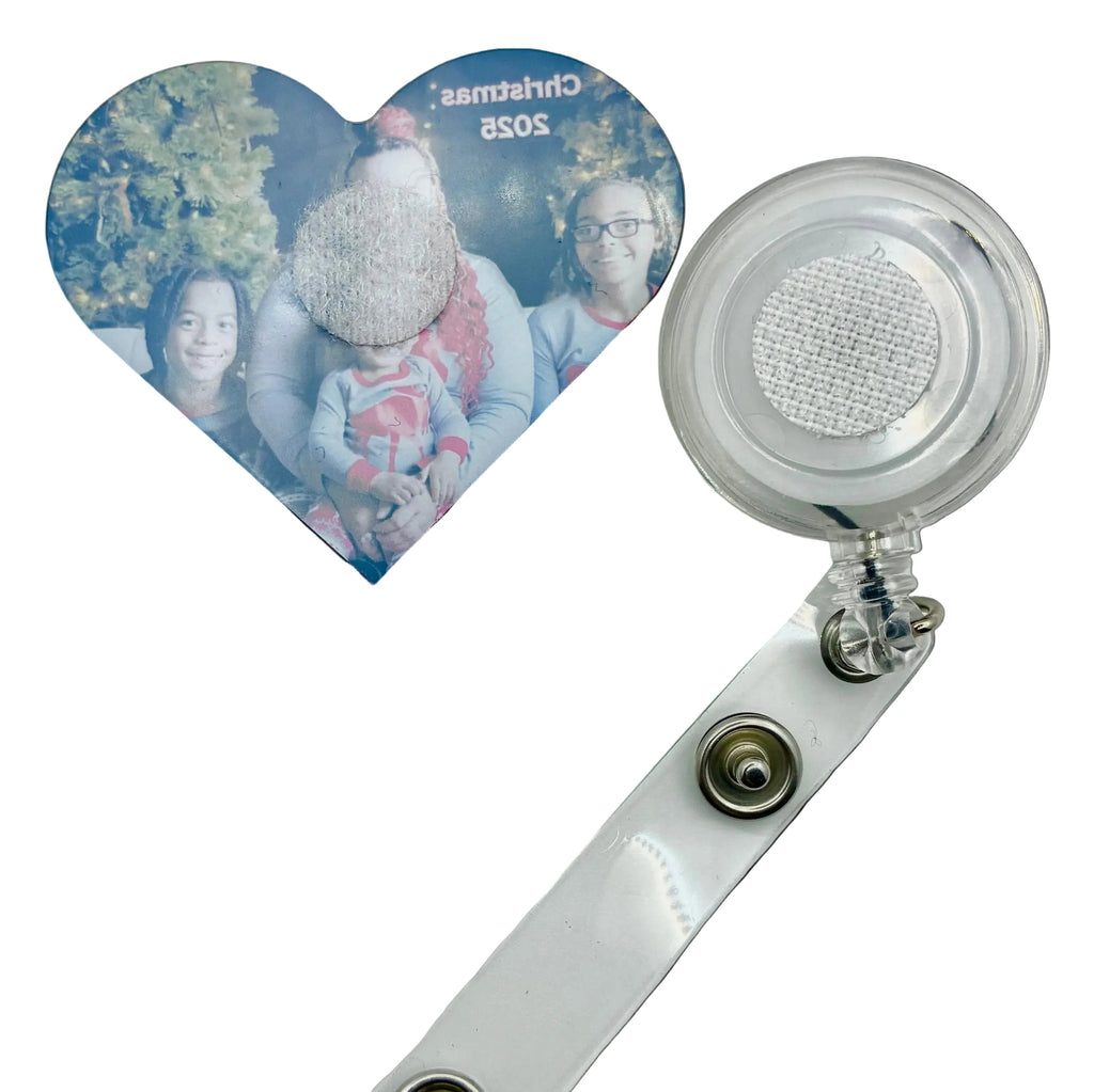 Heart-shaped photo holder with a clear badge reel on a white background